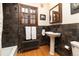 Charming bathroom with pedestal sink and stone tile at 636 York St, Denver, CO 80206