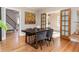 Dining area with hardwood floors, dark wood table, and access to kitchen at 636 York St, Denver, CO 80206