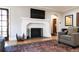 Living room fireplace with white brick surround and hardwood floors at 636 York St, Denver, CO 80206