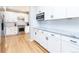 White kitchen features stainless steel appliances and hardwood floors at 636 York St, Denver, CO 80206