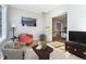 Bright living room featuring hardwood floors, stylish armchairs, and a seamless layout into the dining area at 636 York St, Denver, CO 80206