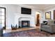 Bright living room featuring a fireplace, hardwood floors, and a classic, neutral decor at 636 York St, Denver, CO 80206