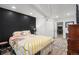 Cozy bedroom featuring a textured wall and easy access to the living room and dining area at 15776 E 107Th Way, Commerce City, CO 80022