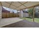 Large covered backyard patio with shed overlooking fenced yard at 265 Cleveland Ct, Bennett, CO 80102