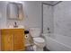 This bathroom features a white marble tiled shower over tub, and a wood vanity with a sink at 265 Cleveland Ct, Bennett, CO 80102