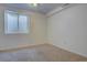 This bedroom has neutral paint, neutral carpet, and a window well letting in natural light at 265 Cleveland Ct, Bennett, CO 80102