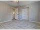 This bedroom has light gray paint, vinyl plank flooring, and a closet at 265 Cleveland Ct, Bennett, CO 80102