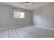 Bright bedroom with gray walls, ceiling fan, wood-look flooring, and natural light from a window at 265 Cleveland Ct, Bennett, CO 80102