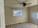 Cozy bedroom with ceiling fan and a window overlooking the neighborhood at 265 Cleveland Ct, Bennett, CO 80102