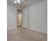 Bedroom with tan carpet, a closet and an ensuite bathroom at 265 Cleveland Ct, Bennett, CO 80102