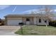 Charming single-story home with brick accents, a well-maintained lawn, and an attached two-car garage at 265 Cleveland Ct, Bennett, CO 80102