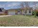 Charming ranch-style home with a well-manicured lawn and attached garage at 265 Cleveland Ct, Bennett, CO 80102