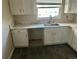 Kitchen area featuring white cabinets, modern countertops, and a stainless steel sink at 265 Cleveland Ct, Bennett, CO 80102