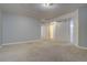 Large open living room with neutral paint and carpet at 265 Cleveland Ct, Bennett, CO 80102