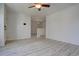 Open living room featuring light gray vinyl plank flooring and neutral paint throughout at 265 Cleveland Ct, Bennett, CO 80102