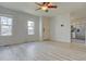 Open living room featuring light gray vinyl plank flooring and neutral paint throughout at 265 Cleveland Ct, Bennett, CO 80102