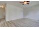 Spacious living room with neutral walls, ceiling fan, wood-look flooring, and natural light at 265 Cleveland Ct, Bennett, CO 80102