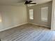 Bright and airy living room has neutral paint, contemporary flooring, and ample natural light at 265 Cleveland Ct, Bennett, CO 80102