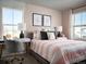 Charming bedroom with pink accents, a desk area, and natural light from two windows at 249 E 4Th St, Berthoud, CO 80513