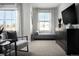 Cozy bedroom with soft carpet, a window bench, and a sleek black dresser at 249 E 4Th St, Berthoud, CO 80513
