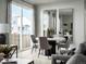 Bright dining area featuring a modern round table and gray chairs by a sliding glass door at 249 E 4Th St, Berthoud, CO 80513
