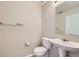 Half bathroom with pedestal sink, a standard toilet and a mirror at 5653 Raleigh Cir, Castle Rock, CO 80104