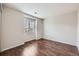 Bright bedroom featuring hardwood floors, and a window for natural light at 5653 Raleigh Cir, Castle Rock, CO 80104