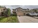 Two-story home with a two-car garage, landscaped front yard, and neutral-colored exterior with a paved driveway at 5653 Raleigh Cir, Castle Rock, CO 80104