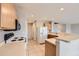 Functional kitchen with neutral countertops and tile flooring next to staircase and open-concept design at 5653 Raleigh Cir, Castle Rock, CO 80104