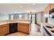 Open kitchen with breakfast bar overlooking the living area and sliding door to the exterior at 5653 Raleigh Cir, Castle Rock, CO 80104