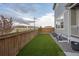 Backyard featuring new sod, a wood fence, and the side of the house at 9590 Sedalia St, Commerce City, CO 80022