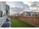 Enclosed backyard with wooden fence and artificial grass, perfect for outdoor entertaining and relaxation at 9590 Sedalia St, Commerce City, CO 80022