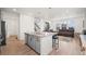 Open-concept kitchen featuring a breakfast bar island flowing into the living area at 9590 Sedalia St, Commerce City, CO 80022