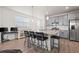 Bright open kitchen with granite countertops, stainless steel appliances, and bar seating at 9590 Sedalia St, Commerce City, CO 80022