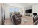 Inviting living room featuring an electric fireplace, lots of natural light and comfortable seating at 9590 Sedalia St, Commerce City, CO 80022