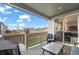 Covered patio featuring outdoor seating, a table, and a grill with a view of the neighborhood at 9590 Sedalia St, Commerce City, CO 80022