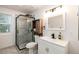 Updated bathroom features tiled shower with frameless glass enclosure and modern vanity at 192 Little Creek Rd, Idaho Springs, CO 80452