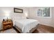 Cozy bedroom with a comfortable bed, side tables, lamps, and natural light from the window at 192 Little Creek Rd, Idaho Springs, CO 80452