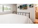 Bedroom featuring minimalist decor, a wall-mounted TV, and an ensuite bathroom at 192 Little Creek Rd, Idaho Springs, CO 80452