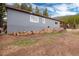 Home exterior with siding, a covered porch and visible firewood showing the ample storage at 192 Little Creek Rd, Idaho Springs, CO 80452
