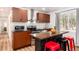 Bright kitchen with wood cabinets, stainless steel appliances, and stylish breakfast bar with bar stools at 192 Little Creek Rd, Idaho Springs, CO 80452