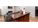 Open kitchen and living room layout with wood island, stainless appliances, and wood floors at 192 Little Creek Rd, Idaho Springs, CO 80452