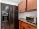 Kitchen showcasing a black refrigerator, wooden cabinets, and countertop appliances at 192 Little Creek Rd, Idaho Springs, CO 80452