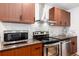 Well-equipped kitchen featuring stainless steel appliances, wood cabinets, and solid surface countertops at 192 Little Creek Rd, Idaho Springs, CO 80452