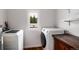 Functional laundry room with modern washer and dryer units and storage space at 192 Little Creek Rd, Idaho Springs, CO 80452