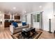 Open-concept living room and kitchen with wood floors and picturesque window views at 192 Little Creek Rd, Idaho Springs, CO 80452