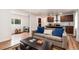 Comfortable living room with kitchen view, featuring hardwood floors and a gray couch at 192 Little Creek Rd, Idaho Springs, CO 80452