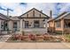 Inviting white brick home featuring a charming front porch and delightful rose garden at 2925 E 14Th Ave, Denver, CO 80206