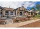 Charming white brick home with a cozy front porch and vibrant rose bushes at 2925 E 14Th Ave, Denver, CO 80206