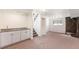 Finished basement with stone fireplace, wet bar, and access to stairs at 8721 E Cornell Dr, Denver, CO 80231